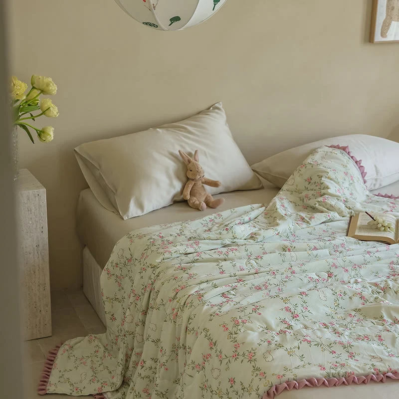 Sommer-Steppdecke mit Blumen- und Hasenmotiv und Rüschenbesatz