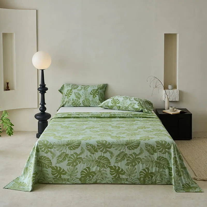 Grüne Tagesdecke aus Baumwollgaze-Jacquard mit Monstera-Motiv