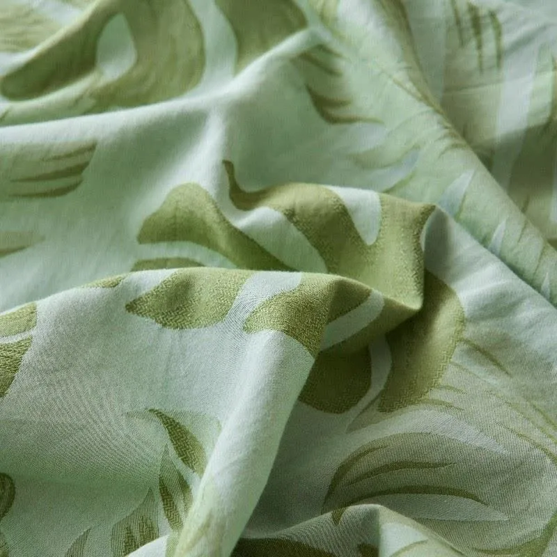 Grüne Tagesdecke aus Baumwollgaze-Jacquard mit Monstera-Motiv