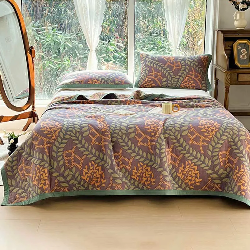 Wendesteppdecke aus Baumwolle mit grünen und orangefarbenen Blättern